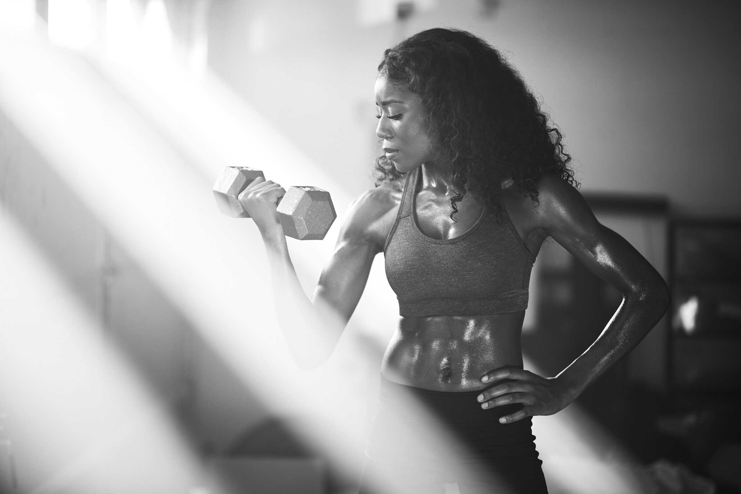 Fit African American Woman Lifting Dumbbells